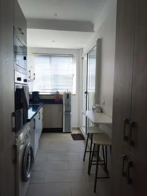 a kitchen with a washer and dryer and a sink at Apart 3ch 2sdb salon Centre ville in Casablanca