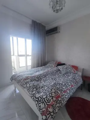 a bedroom with a bed with a black and white comforter at Apart 3ch 2sdb salon Centre ville in Casablanca