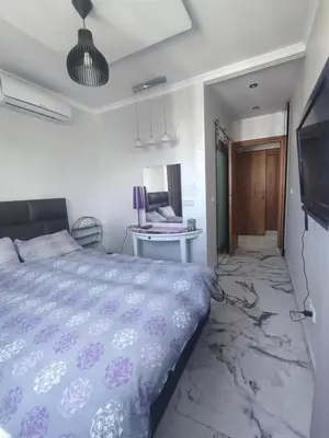 a bedroom with a bed and a desk and a tv at Apart 3ch 2sdb salon Centre ville in Casablanca