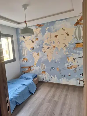 a bedroom with a mural of a map of the world at Bel appartement familial résidence sécurisée in Casablanca