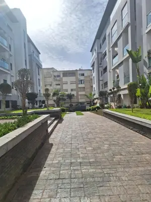 an empty street in front of apartment buildings at Bel appartement familial résidence sécurisée in Casablanca