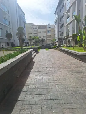 an empty street in a city with buildings at Bel appartement familial résidence sécurisée in Casablanca