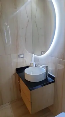 a bathroom with a sink and a mirror at Bel appartement familial résidence sécurisée in Casablanca