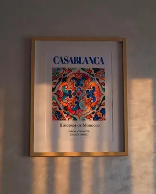 a framed picture of a painting on a wall at Appartement Vue Mer & Coucher de Soleil in Aïn Harrouda