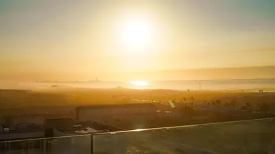 a view of the sun setting over the beach at Appartement Vue Mer & Coucher de Soleil in Aïn Harrouda