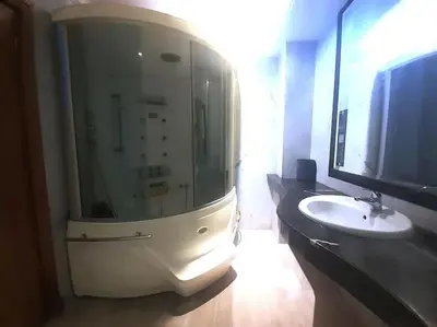 a bathroom with a glass shower and a sink at Appartement 380M BD El Massira Maarif in Casablanca