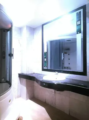 a bathroom with a sink and a large mirror at Appartement 380M BD El Massira Maarif in Casablanca