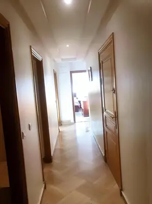 an empty hallway with two doors and a hallwayngth at Appartement 380M BD El Massira Maarif in Casablanca
