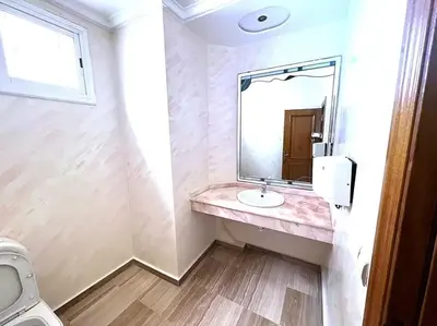 a bathroom with a sink and a mirror at Appartement 380M BD El Massira Maarif in Casablanca