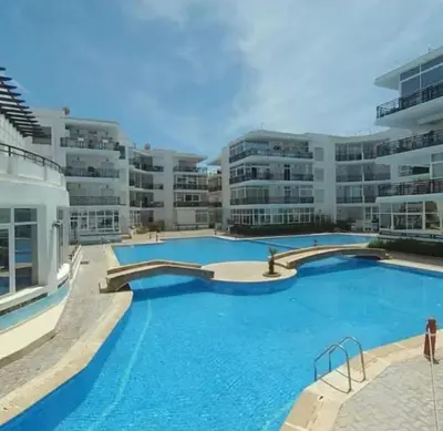 a large swimming pool in front of a building at Appartement Vue Panoramique sur la siesta plage WELCOME STAY in Mohammedia