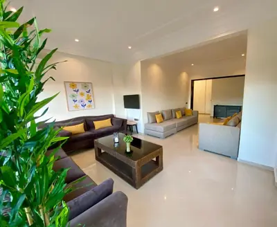 a living room with couches and a coffee table at Appartement Vue Panoramique sur la siesta plage WELCOME STAY in Mohammedia