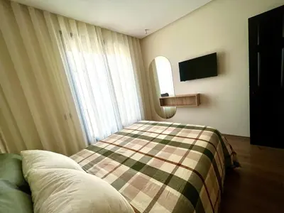 a bedroom with a bed with a plaid blanket at Cozy apartment Casablanca in Casablanca