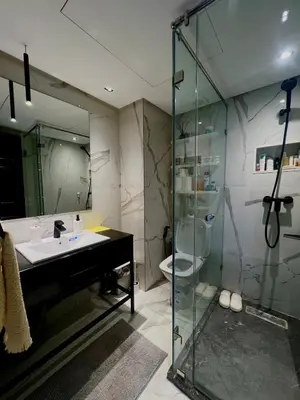a bathroom with a sink and a glass shower at Cozy apartment Casablanca in Casablanca