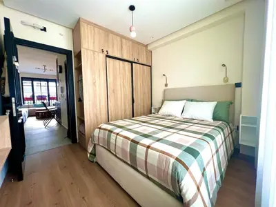 a bedroom with a bed with a striped blanket at Cozy apartment Casablanca in Casablanca