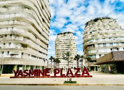 two tall apartment buildings with a sign in front of them at Sunshine Apartment in Casablanca