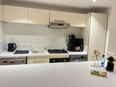 a kitchen with white cabinets and a white counter top at Sunshine Apartment in Casablanca