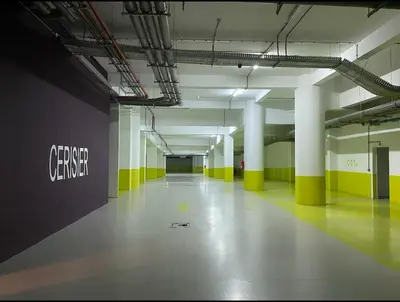 an empty parking garage with yellow and white columns at Sunshine Apartment in Casablanca