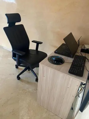 a desk with a chair and a laptop computer on it at Quiet and spacious modern apartment near TGV station in Rabat