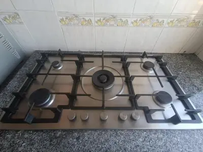 a stove top with four burners on top of it at Quiet and spacious modern apartment near TGV station in Rabat