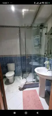 a bathroom with a shower and a toilet and a sink at Quiet and spacious modern apartment near TGV station in Rabat