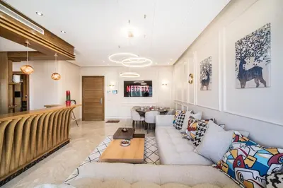 a living room with a couch and a table at Contemporary apartment in CFC Anfa in Casablanca