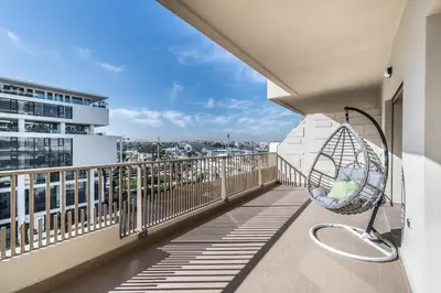a balcony with a chair on a building at Contemporary apartment in CFC Anfa in Casablanca