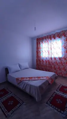 a bedroom with two beds and a window at Luxurious space in Oulad Kerroum