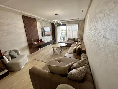 a living room with couches and a couch and a table at Condo beach view in Casablanca in Casablanca