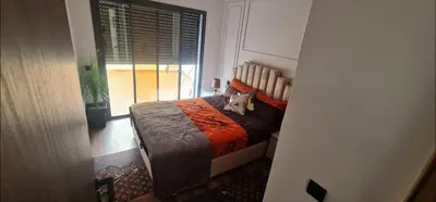 a cat sitting on a bed in a bedroom at SUPER HIGH 12 standing studio at Maarif in Maarif