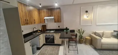 a kitchen with a stove and a couch in a room at SUPER HIGH 12 standing studio at Maarif in Maarif