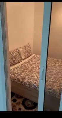 a bedroom with a bed in a room with a mirror at Un petit studio in Settat