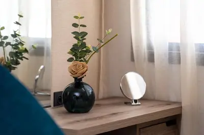 a black vase sitting on a table with a mirror at Beautiful new studio with a Seaview 8 in Casablanca