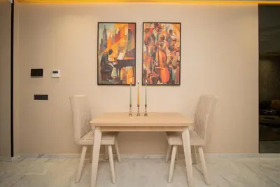 a table with two chairs and a painting on the wall at Beautiful new studio with a Seaview 8 in Casablanca