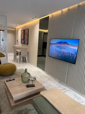 a living room with a tv hanging on a wall at Beautiful new studio with a Seaview 8 in Casablanca