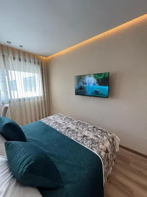 a bedroom with a bed with a tv on the wall at Beautiful new studio with a Seaview 8 in Casablanca