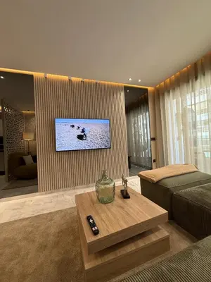 a living room with a couch and a tv on a wall at Beautiful new studio with a Seaview 8 in Casablanca