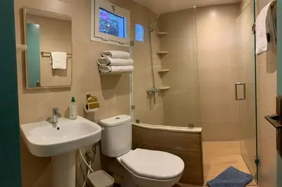 a bathroom with a toilet and a sink and a shower at Palmeraie 3 in Skhirat