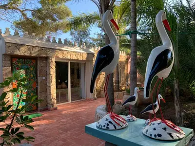 a statue of birds on a table in front of a house at Palmeraie 3 in Skhirat