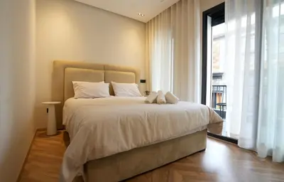 a bedroom with a large bed and a large window at Blue Skies Residence, Luxury Apartment, City Center in Casablanca