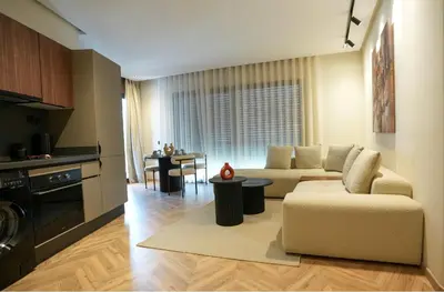 a living room with a couch and a table at Blue Skies Residence, Luxury Apartment, City Center in Casablanca