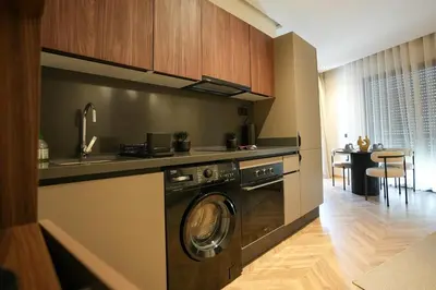 a kitchen with a washing machine in a kitchen at Blue Skies Residence, Luxury Apartment, City Center in Casablanca