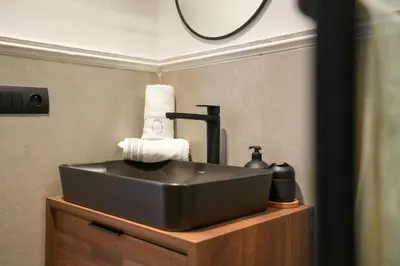 a bathroom with a black sink and a mirror at Blue Skies Residence, Luxury Apartment, City Center in Casablanca