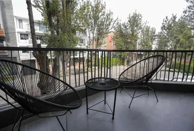 two chairs and a table on a balcony at Blue Skies Residence, Luxury Apartment, City Center in Casablanca