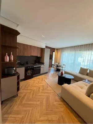 a large living room with a couch and a kitchen at Blue Skies Residence, Luxury Apartment, City Center in Casablanca