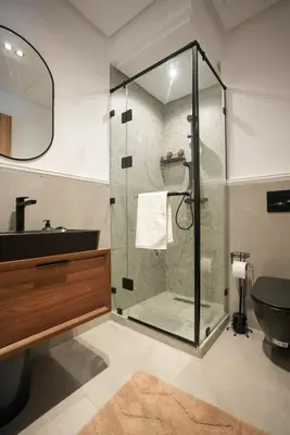 a bathroom with a glass shower and a sink at Blue Skies Residence, Luxury Apartment, City Center in Casablanca
