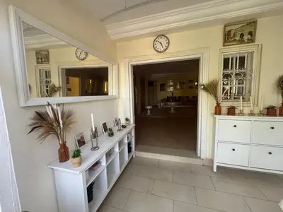 a bathroom with white cabinets and clocks on the wall at Villa luxueuse à Skhirat Rabat in Skhirat