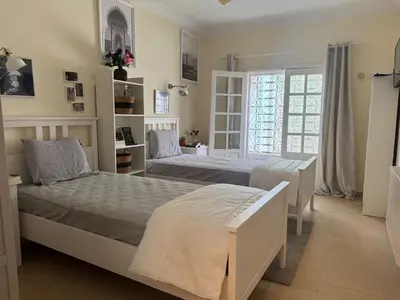 a bedroom with two beds and a window at Villa luxueuse à Skhirat Rabat in Skhirat