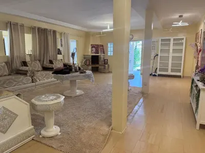 a living room with a couch and a table at Villa luxueuse à Skhirat Rabat in Skhirat