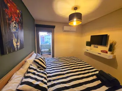 a bedroom with a bed and a television in it at Luxe & Confort in Cité de Bournazel