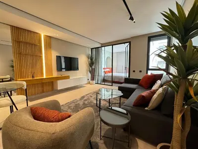 a living room with a couch and chairs and a tv at الدار بيضاء in Casablanca